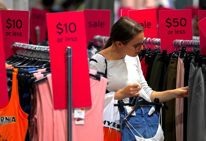 &copy; Reuters. FILE PHOTO - A shopper holds items and looks at others on sale at a clothing retail store in central Sydney, Australia, March 19, 2017. REUTERS/Steven Saphore/File Photo 