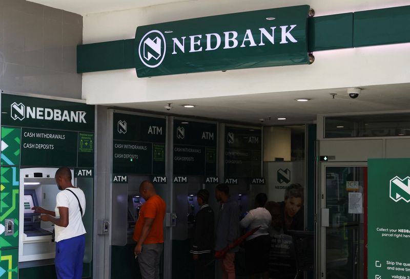 &copy; Reuters. FILE PHOTO: Customers perform transactions on Nedbank automated teller machine (ATM)  at the Trade Route Mall, in Lenasia outside Johannesburg, South Africa, February 8, 2023. REUTERS/Siphiwe Sibeko