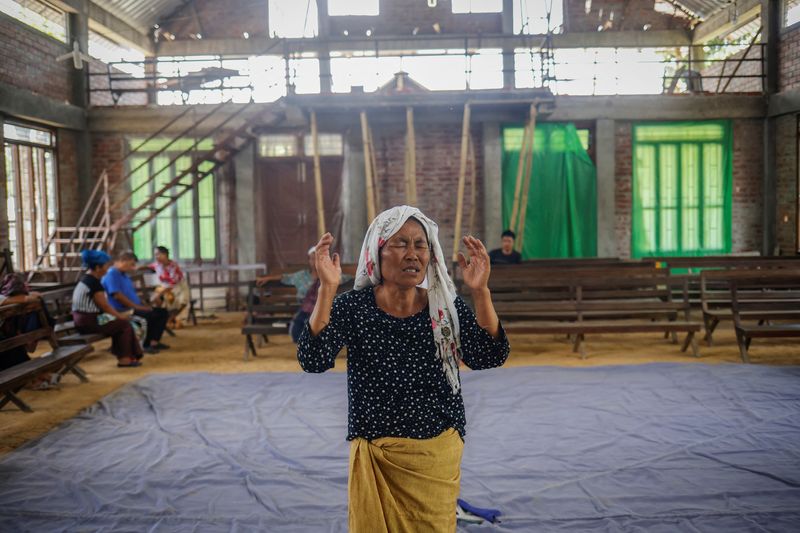 &copy; Reuters. FILE PHOTO: A Kuki woman prays inside a church at Kangvai village in Churachandpur district in the northeastern state of Manipur, India, July 23, 2023. REUTERS/Adnan Abidi/file photo