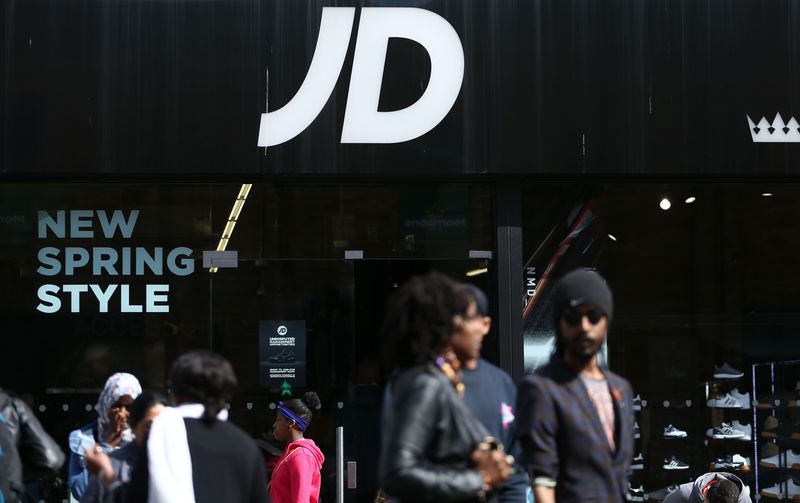 &copy; Reuters. FILE PHOTO: People pass a JD Sports store in London, Britain April 11, 2017. REUTERS/Neil Hall/File Photo