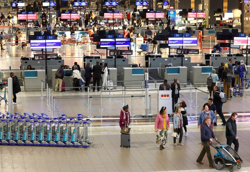 &copy; Reuters. FILE PHOTO: Passengers walk next to check-in counters at the O.R. Tambo International Airport, in Johannesburg, South Africa, July 3, 2023. REUTERS/Siphiwe Sibeko/File Photo