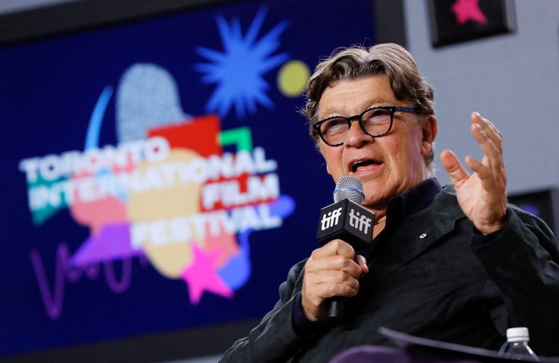 © Reuters. FILE PHOTO: Musician Robbie Robertson gestures as he speaks during a news conference for the biopic 