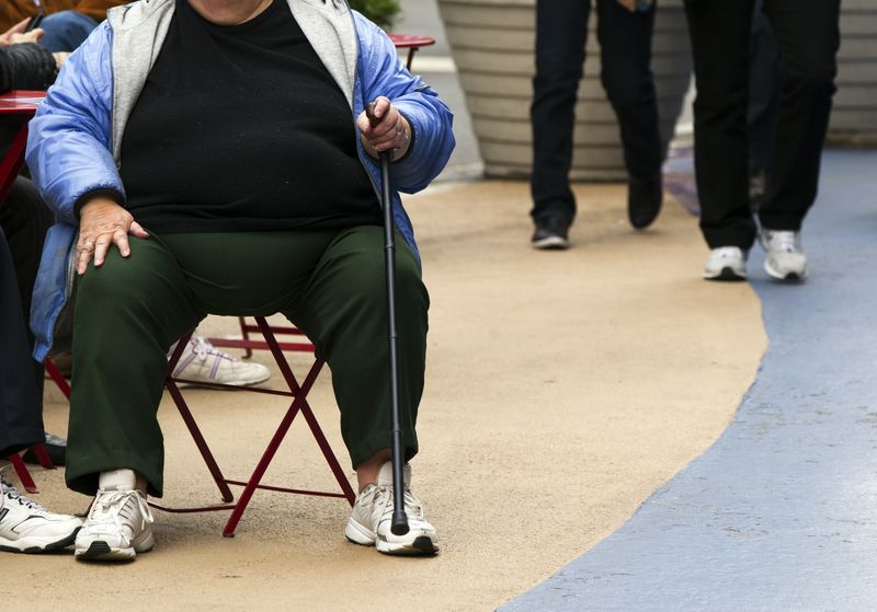 &copy; Reuters. FILE PHOTO: An overweight woman sits on a chair in Times Square in New York, May 8, 2012. America's obesity epidemic is so deeply rooted that it will take dramatic and systemic measures - from overhauling farm policies and zoning laws to, possibly, introd