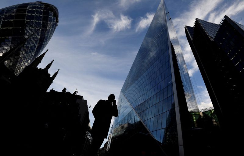 &copy; Reuters. FILE PHOTO: A man speaks on his phone as he walks past the Gherkin and other office buildings in the City of London, Britain November 13, 2018. REUTERS/Toby Melville/File Photo