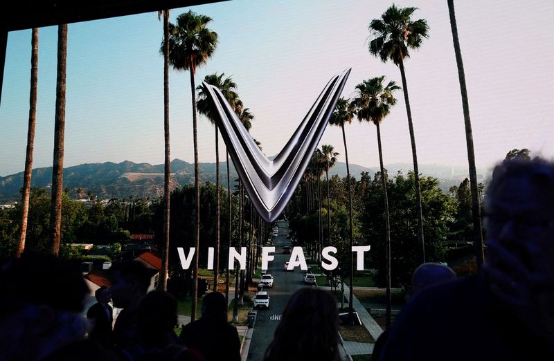&copy; Reuters. FILE PHOTO: People walk next to a VinFast logo on a screen during the press day at the Los Angeles Auto Show in Los Angeles, California, U.S. November 17, 2022. REUTERS/Mike Blake/File Photo