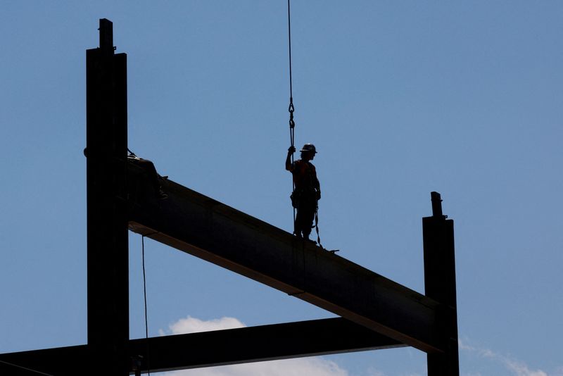 © Reuters. FILE PHOTO: A member of the Ironworkers Local 7 union installs steel beams on high-rise building under construction during a summer heat wave in Boston, Massachusetts, U.S., June 30, 2021. REUTERS/Brian Snyder