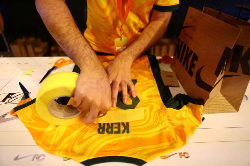 &copy; Reuters. FILE PHOTO: Soccer Football - A worker applies the name and number of Australia's Sam Kerr to a football jersey in the Nike FC shop in Sydney, Australia, August 14, 2023 REUTERS/Carl Recine/File Photo