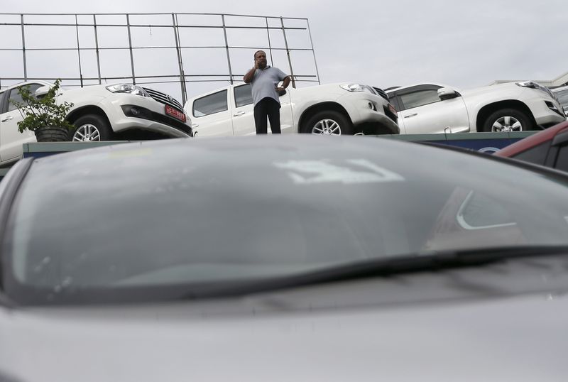 &copy; Reuters. A customer uses his mobile phone at a car showroom in Colombo October 9, 2015. REUTERS/Dinuka Liyanawatte/File Photo