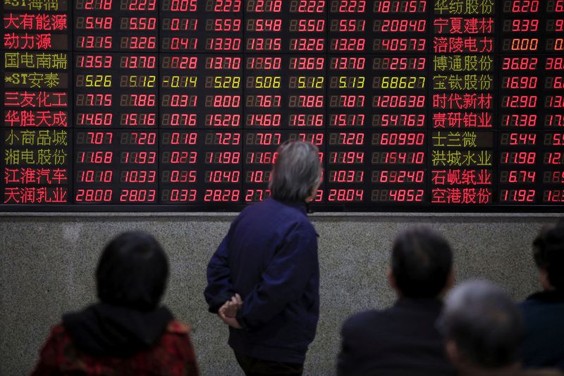 &copy; Reuters. FILE PHOTO: Investors look at an electronic board showing stock information at a brokerage house in Shanghai, China, March 7, 2016. REUTERS/Aly Song/File Photo   