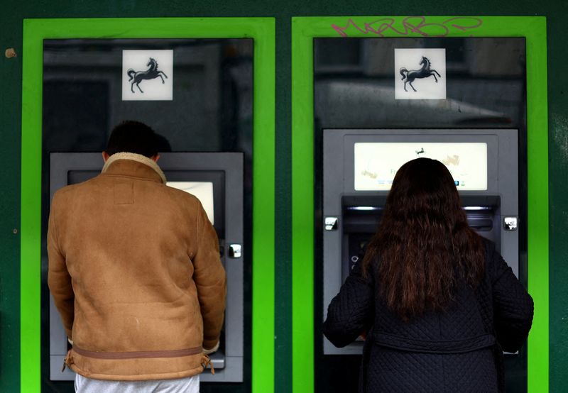 © Reuters. FILE PHOTO: People use an ATM cash machine in London, Britain, September 27, 2022. REUTERS/Hannah McKay/File Photo