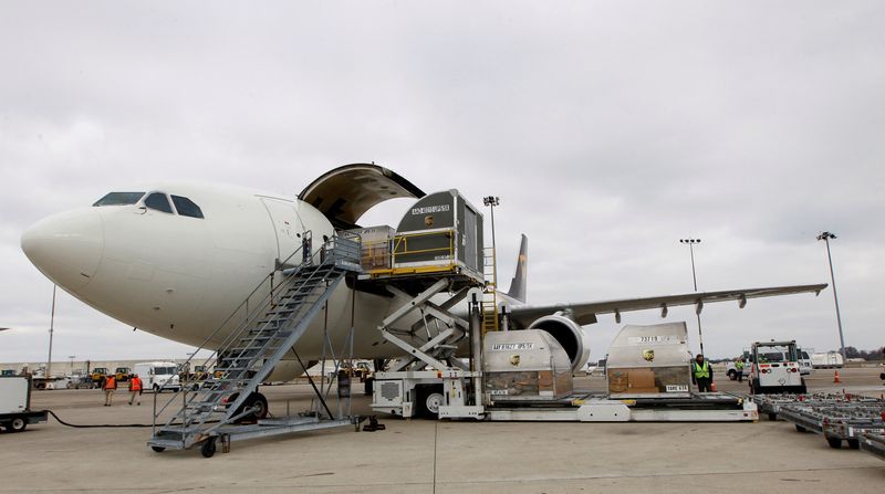 &copy; Reuters. FILE PHOTO: United Parcel Service aircraft are loaded and unloaded with air containers full of packages bound for their final destination at the UPS Worldport All Points International Hub during the peak delivery season in Louisville, Kentucky, December 9