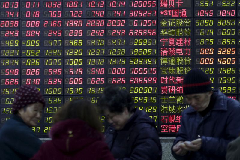 &copy; Reuters. FILE PHOTO: Investors stand in front of an electronic board showing stock information on the first trading day after the week-long Lunar New Year holiday at a brokerage house in Shanghai, China, February 15, 2016. REUTERS/Aly Song/File Photo