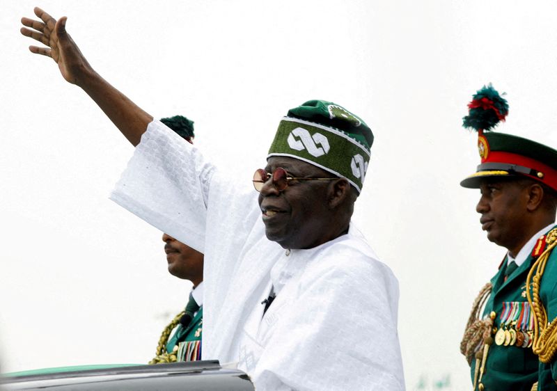 &copy; Reuters. FILE PHOTO: Nigeria's President Bola Tinubu waves to a crowd as he takes the traditional ride on top of a ceremonial vehicle, after his swearing-in ceremony in Abuja, Nigeria May 29, 2023. REUTERS/Temilade Adelaja/File Photo