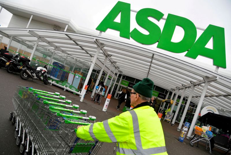 &copy; Reuters. FILE PHOTO: A worker pushes shopping trolleys at an Asda store in West London, Britain, April 28, 2018. REUTERS/Toby Melville/File Photo