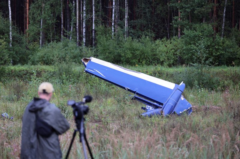 &copy; Reuters. A cameraman films a wreckage of the private jet linked to Wagner mercenary chief Yevgeny Prigozhin near the crash site in the Tver region, Russia, August 24, 2023. REUTERS/Marina Lystseva    