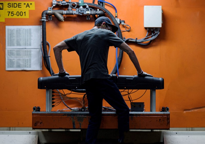 &copy; Reuters. FILE PHOTO: A person works at an injection molding station at the Polaris manufacturing and assembly plant in Roseau, Minnesota, U.S. June 7, 2021. Picture taken June 7, 2021. REUTERS/Dan Koeck