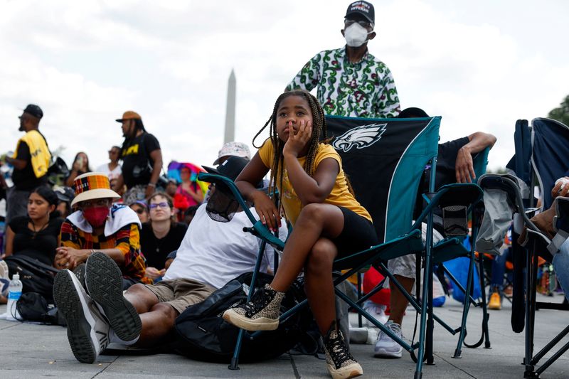 © Reuters. People attend a racial justice demonstration on the 60th anniversary of the March On Washington and Martin Luther King Jr's historic 