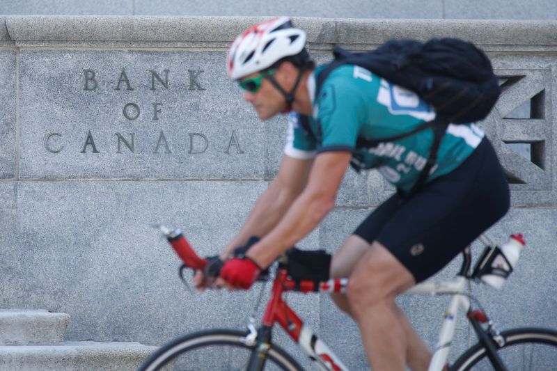 &copy; Reuters. A cyclist rides past the Bank of Canada building, Ontario, Canada, July 11, 2018. REUTERS/Chris Wattie