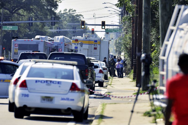 &copy; Reuters. Emergency personnel surround a Dollar General store after a white man armed with a high-powered rifle and a handgun killed three Black people before shooting himself, in what local law enforcement described as a racially motivated crime in Jacksonville, F