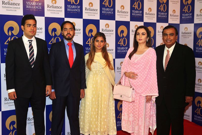 &copy; Reuters. FILE PHOTO: Mukesh Ambani (R), Chairman and Managing Director of Reliance Industries, poses with (from 2nd R to L) wife Nita Ambani, children Isha Ambani, Anant Ambani, and Akash Ambani before addressing the company's annual general meeting in Mumbai, Ind