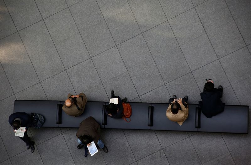 &copy; Reuters. FILE PHOTO: People sit on a bench at a convention centre in a financial district in Tokyo, Japan, January 26, 2017. REUTERS/Kim Kyung-Hoon/File Photo