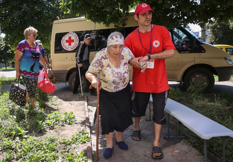 &copy; Reuters. متطوع في الصليب الأحمر يساعد امرأة مسنة على الإخلاء من مدينة كوبيانسك في منطقة خاركيف بأوكرانيا يوم 15 أغسطس آب 2023. تصوير: فياتشيسلاف ماديفسك