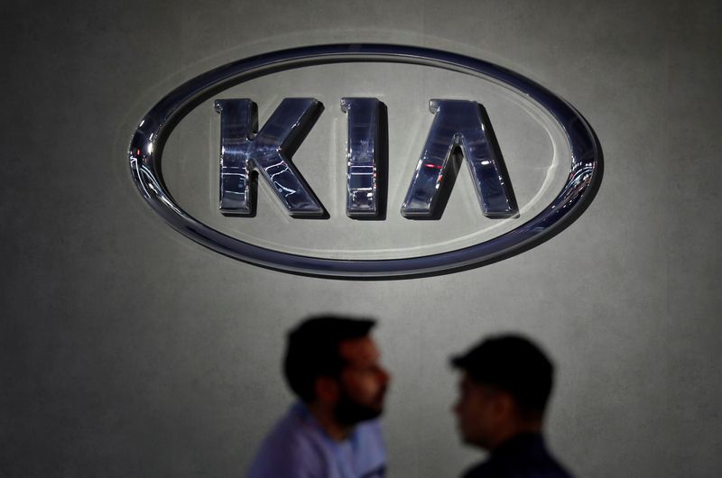 &copy; Reuters. FILE PHOTO: Visitors walk past the logo of Kia Motors at its pavilion at the India Auto Expo 2020 in Greater Noida, India, February 5, 2020. REUTERS/Anushree Fadnavis/File Photo