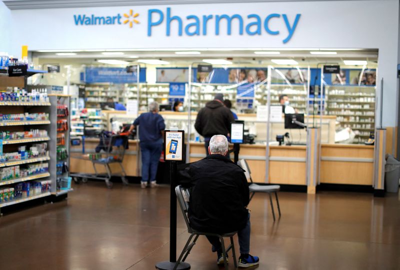 &copy; Reuters. FILE PHOTO: A person waits at a Walmart Pharmacy in West Haven, Connecticut, U.S., February 17, 2021. REUTERS/Mike Segar/File Photo