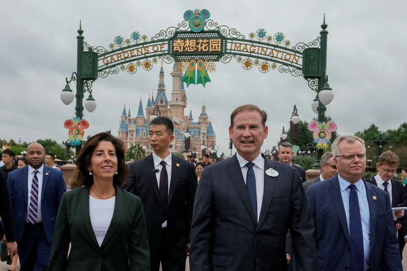 &copy; Reuters. U.S. Commerce Secretary Gina Raimondo, is escorted by officials as she tours the Shanghai Disneyland in Shanghai, China, Wednesday, Aug. 30, 2023. Andy Wong/Pool via REUTERS