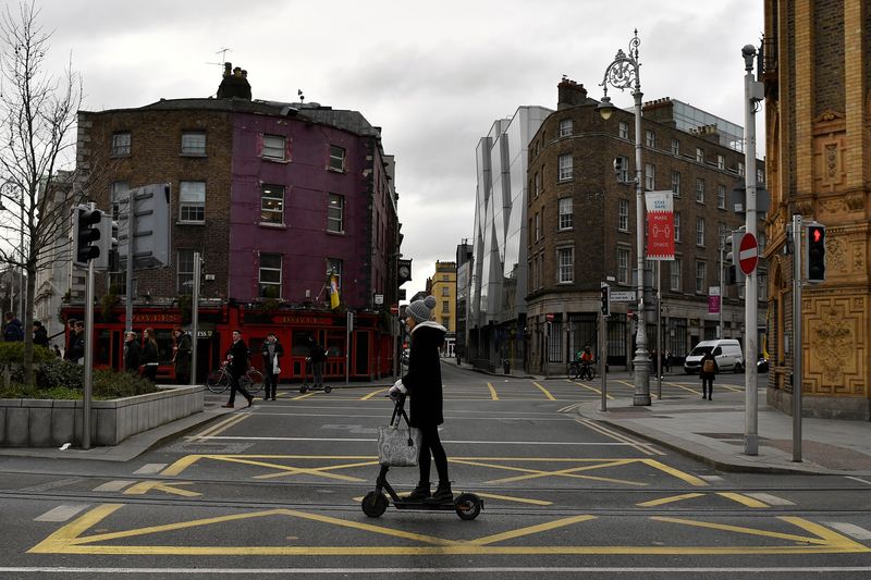 &copy; Reuters. A woman uses an electric scooter in the city centre of Dublin, Ireland, February 11, 2022. REUTERS/Clodagh Kilcoyne/File photo