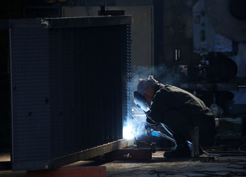 &copy; Reuters. FILE PHOTO: A man works at a factory at the Keihin industrial zone in Kawasaki, Japan February 28, 2017. REUTERS/Issei Kato/File Photo