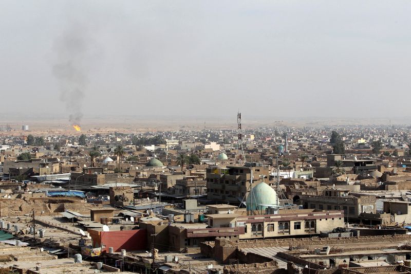 &copy; Reuters. FILE PHOTO: A view of the city of Kirkuk shows a flame from an oilfield in the distance, October 25, 2010.  REUTERS/Saad Shalash