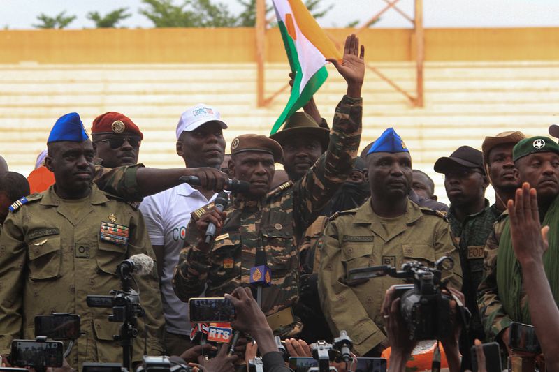 &copy; Reuters. أعضاء المجلس العسكري في النيجر يقفون أمام المؤيدين للانقلاب في العاصمة نيامي في 26 أغسطس آب 2023 . تصوير : محمدو حميدو . يحظر إعادة بيع الصورة أو 