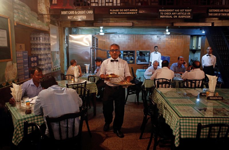 &copy; Reuters. FILE PHOTO: A waiter carries plates of food for customers at the Britannia and Co. restaurant in Mumbai September 19, 2013. REUTERS/Danish Siddiqui/File Photo                                  