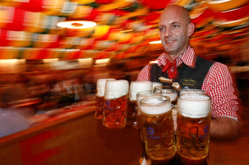 &copy; Reuters. FILE PHOTO: A waiter serves mugs of beer during the opening of the Oktoberfest in Berlin September 9, 2009. REUTERS/Fabrizio Bensch/File Photo                                   