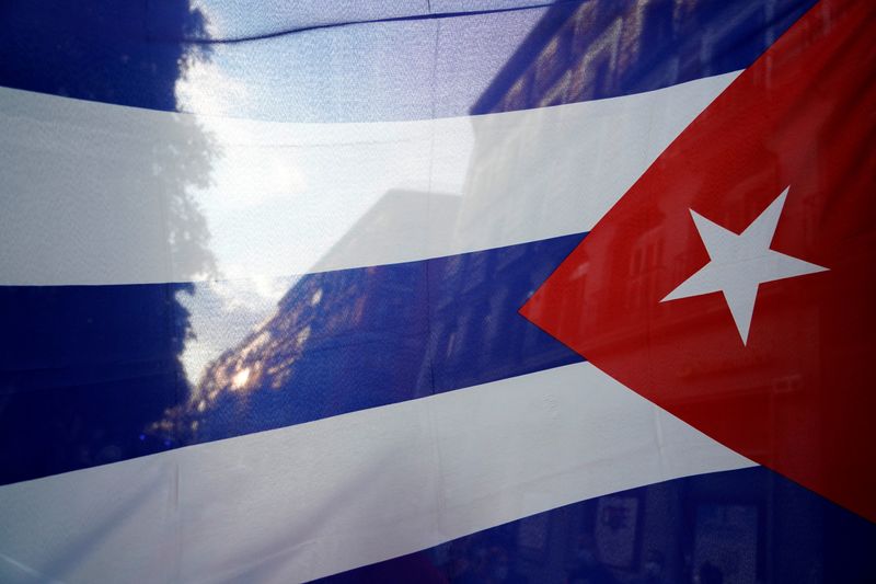 © Reuters. FILE PHOTO: The silhouette of the city is seen through a Cuban flag during a protest against the  U.S. economic embargo in Cuba, in Madrid, Spain, July 26, 2021. REUTERS/Juan Medina/File Photo