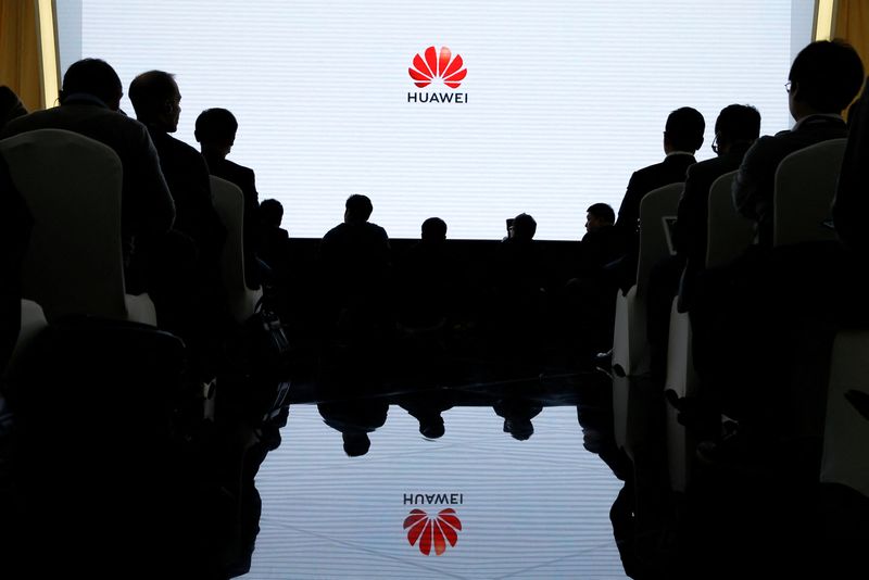 &copy; Reuters. FILE PHOTO: People attend a product presentation at Huawei in Beijing, China, January 24, 2019.   REUTERS/Thomas Peter/File Photo