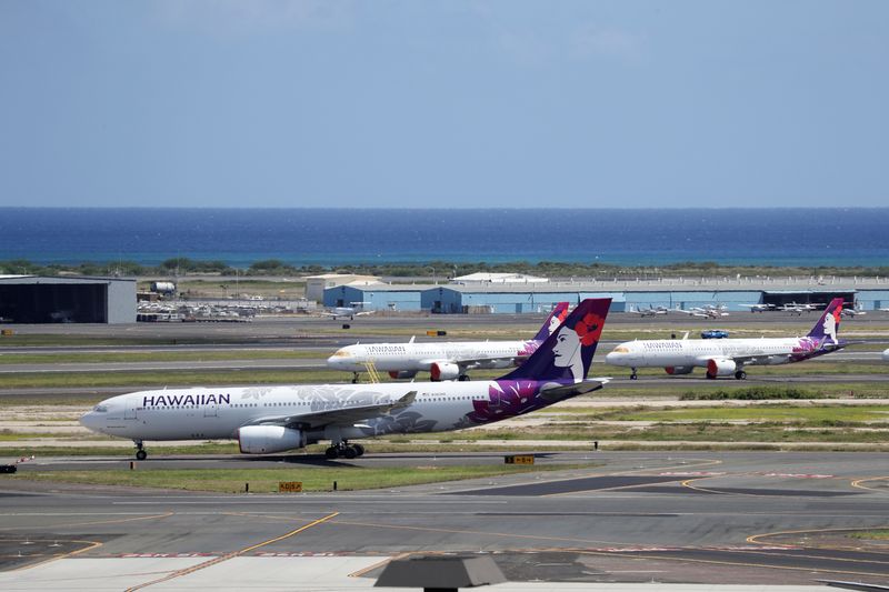 &copy; Reuters. Hawaiian Airlines airplanes sit idle on the runway at the Daniel K. Inouye International Airport due to the business downturn caused by the coronavirus disease (COVID-19) in Honolulu, Hawaii, U.S. April 28, 2020. Picture taken April 28, 2020. REUTERS/Marc