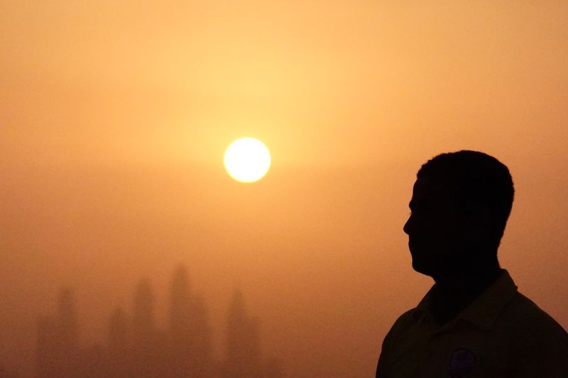 © Reuters. FILE PHOTO: Lifeguard Mohamed stands near a swimming pool while the sun sets over Dubai, United Arab Emirates, August 12, 2023. REUTERS/Amr Alfiky/File Photo