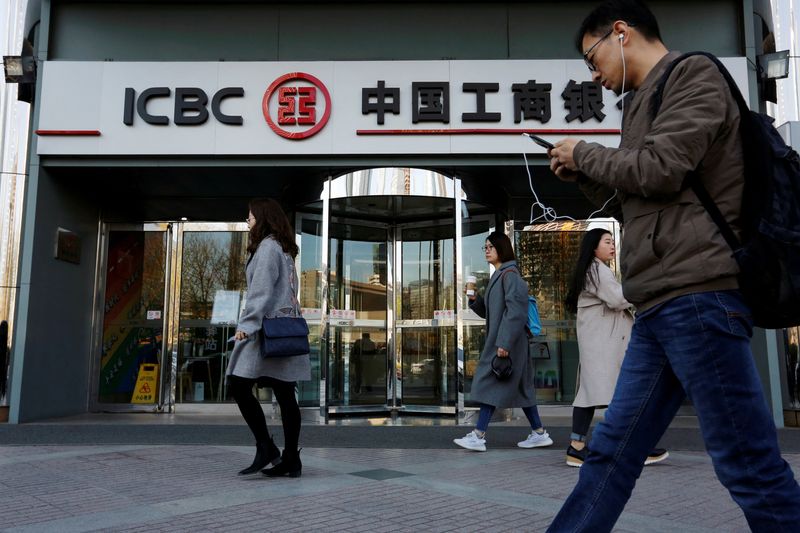 &copy; Reuters. FILE PHOTO: People walk past a branch of Industrial and Commercial Bank of China (ICBC) in Beijing, China April 1, 2019. REUTERS/Florence Lo/File Photo
