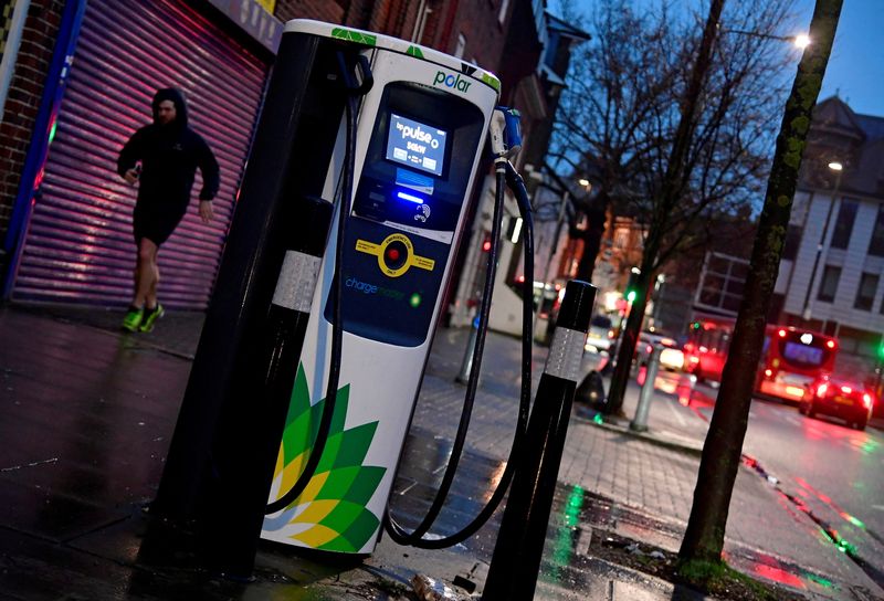 &copy; Reuters. FILE PHOTO: A man runs past a BP EV (Electric Vehicle) charge point in London, Britain, January 30, 2021. REUTERS/Toby Melville/File Photo