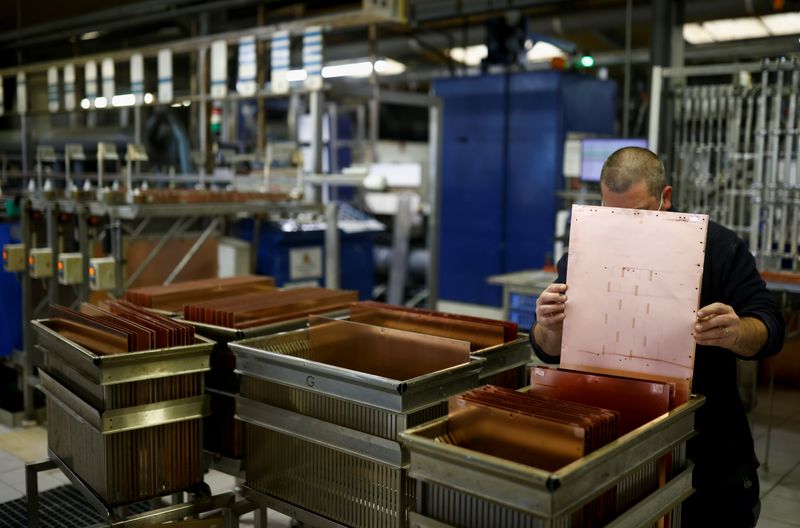 &copy; Reuters. FILE PHOTO: An employee of Atlantec Technologies holds a copper plate as he works on printed circuit boards at the company's factory in Malville near Nantes, France, May 11 2021. REUTERS/Stephane Mahe/File Photo