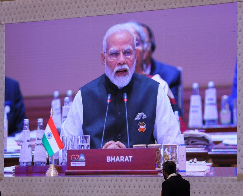 &copy; Reuters. A giant screen displays India's Prime Minister Narendra Modi at the International Media Centre, as he sits behind the country tag that reads "Bharat", while delivering the opening speech during the G20 summit in New Delhi, India, September 9, 2023. REUTER