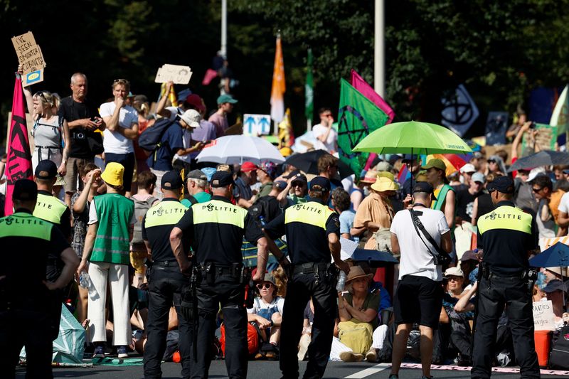 &copy; Reuters. Police officers stand guard as climate activists block the A12 highway in The Hague, Netherlands, September 9, 2023. REUTERS/Piroschka van de Wouw