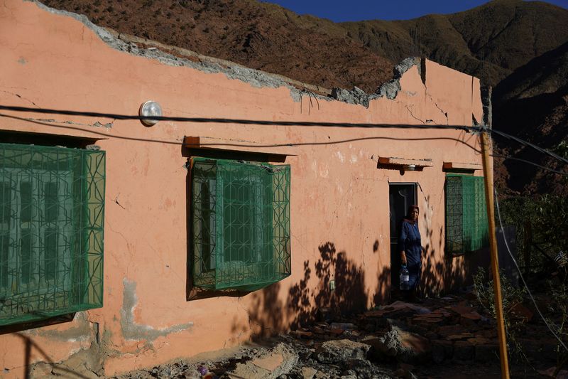 &copy; Reuters. امرأة تخرج من منزل متضرر في أعقاب زلزال مميت هز المغرب على مشارف بلدة تلة يعقوب يوم الاثنين. تصوير: هانا مكاي - رويترز.