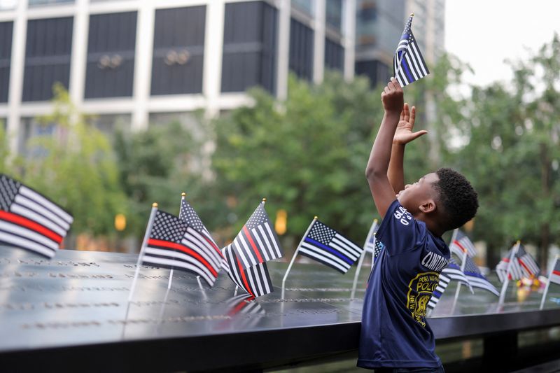 &copy; Reuters. A person holds a flag, on the day of the 22nd anniversary of the September 11, 2001 attacks on the World Trade Center at the National September 11 Memorial & Museum, in New York City, U.S., September 11, 2023. REUTERS/Andrew Kelly