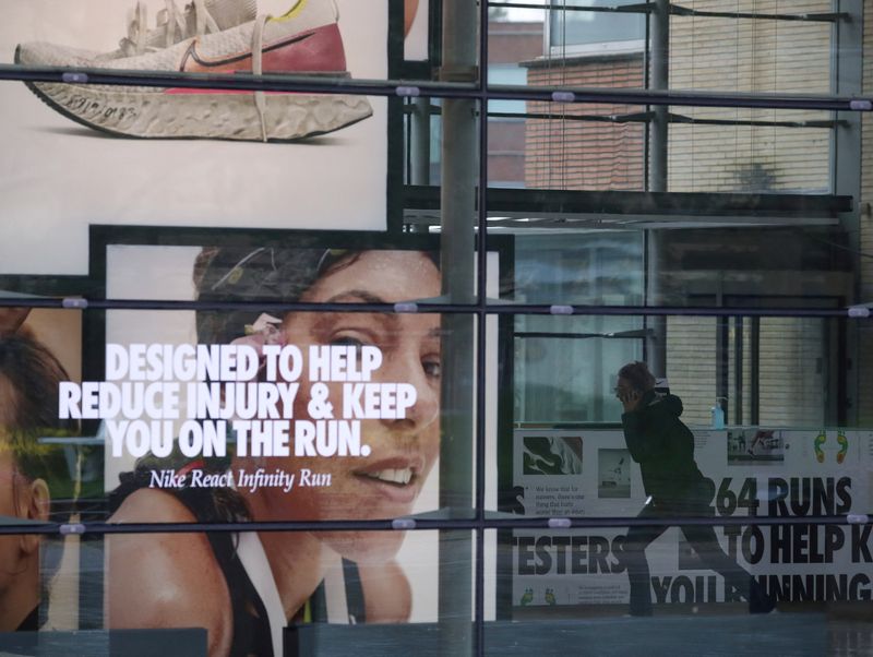 © Reuters. FILE PHOTO: A woman runs inside the Nike European headquarters in Hilversum, Netherlands March 2, 2020. REUTERS/Yves Herman/File Photo