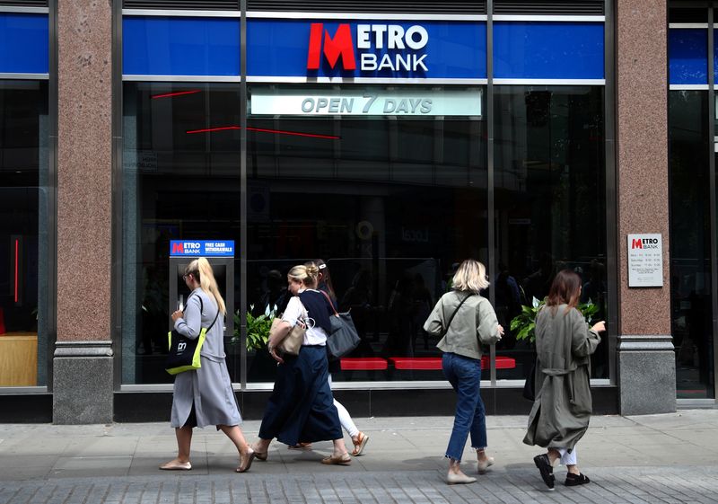 &copy; Reuters. FILE PHOTO: People walk past a Metro Bank in London, Britain, May 22, 2019. REUTERS/Hannah McKay/File Photo
