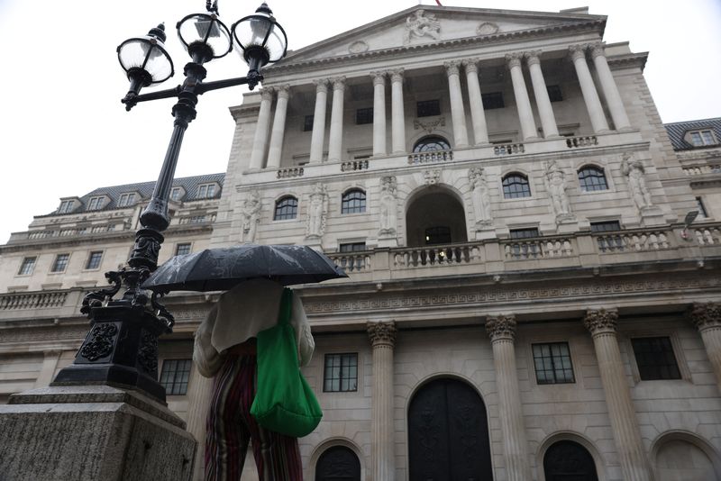 &copy; Reuters. A woman holds an umbrella outside the Bank of England in the City of London, Britain, July 30, 2023. REUTERS/Hollie Adams/File photo