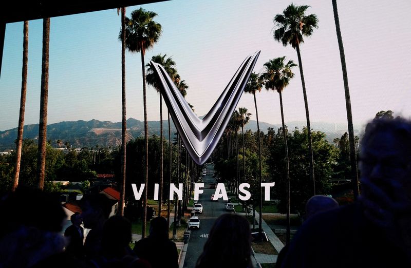 &copy; Reuters. FILE PHOTO: People walk next to a VinFast logo on a screen during the press day at the Los Angeles Auto Show in Los Angeles, California, U.S. November 17, 2022. REUTERS/Mike Blake/File Photo/File Photo